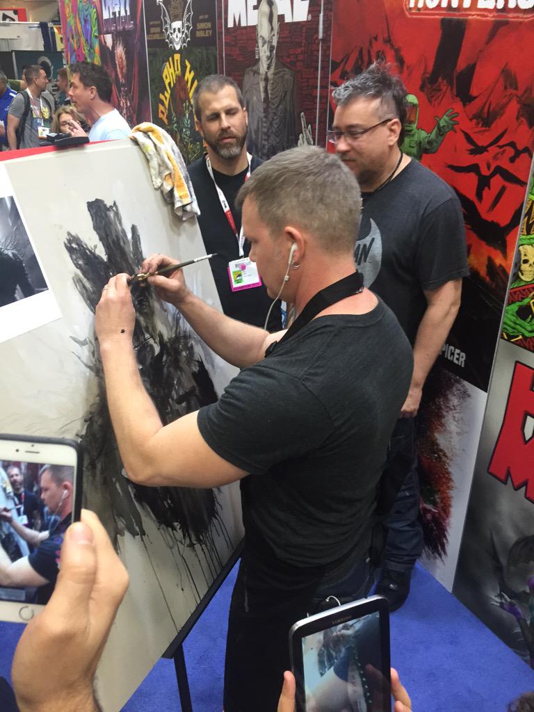Borys_Kit's tweet photo. This is Rob Prior, ambidextrous painter. He is impressing painter Simon Bisley (right) at the Heavy Metal booth. http://t.co/NdD8jYOq0H