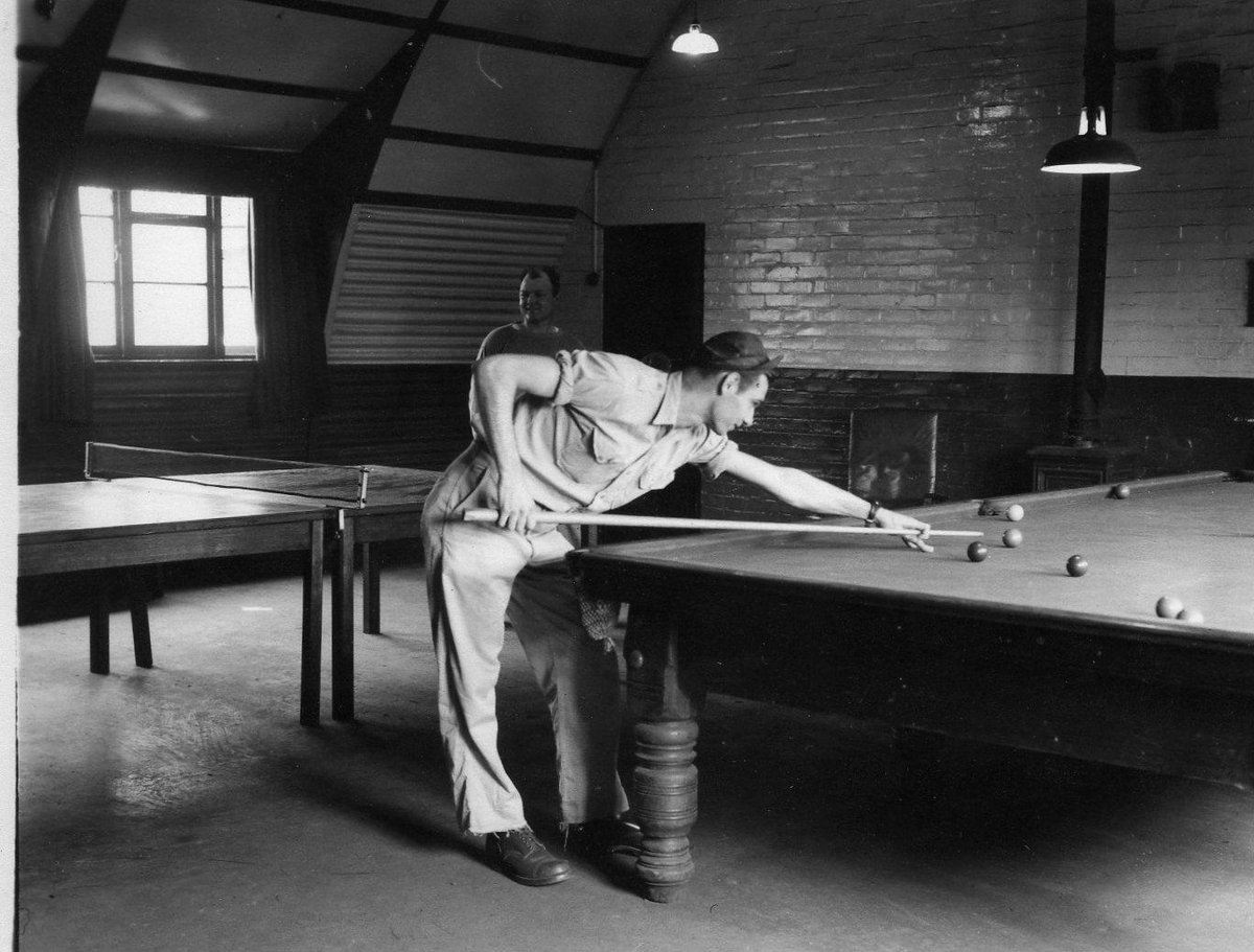 A couple of chaps of the 94th enjoy the aero club room during wartime