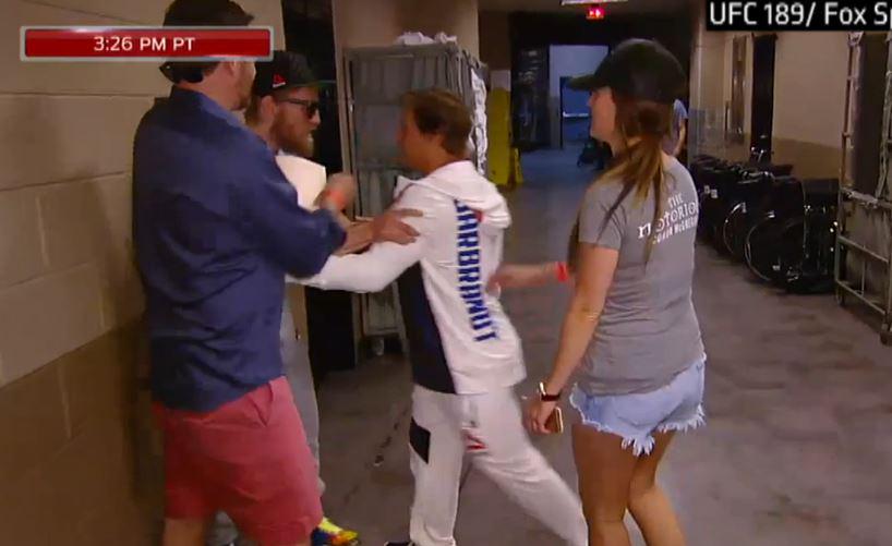 espn's tweet photo. Before the #UFC189 ​weigh-ins, Conor McGregor​ and Urijah Faber​ had an altercation. WATCH: http://t.co/3S4Pi61Fda http://t.co/Q8zYJsICM5