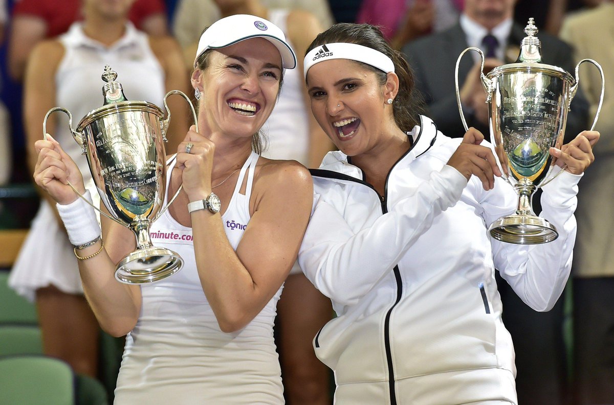 timesofindia's tweet photo. #Wimbledon: #SaniaMirza creates history, wins women's doubles with Hingis http://t.co/fmLdOLXbWS http://t.co/FwABmkc5xv