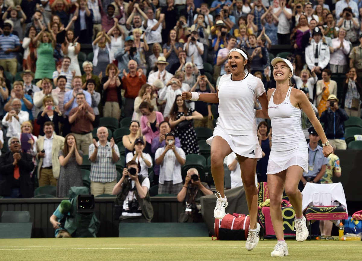timesofindia's tweet photo. #Wimbledon: #SaniaMirza creates history, wins women's doubles with Hingis http://t.co/fmLdOLXbWS http://t.co/FwABmkc5xv