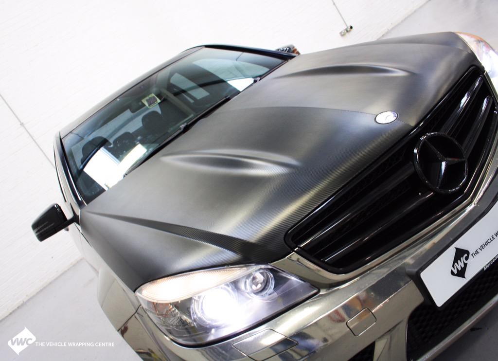 This Mercedes C63 AMG wrapped in Black Chrome with bonnet &amp; roof wrapped in 3M's new straight weave Carbon Fibre