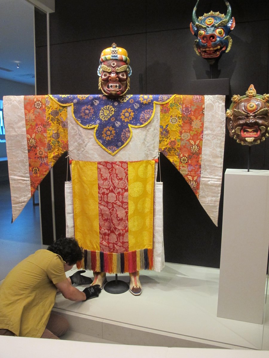 RubinMuseum's tweet photo. Our Collections Mgmt. team is rotating out a robe & mask from #BecomingAnother to limit exposure to light & humidity http://t.co/JaCiPcd1dK