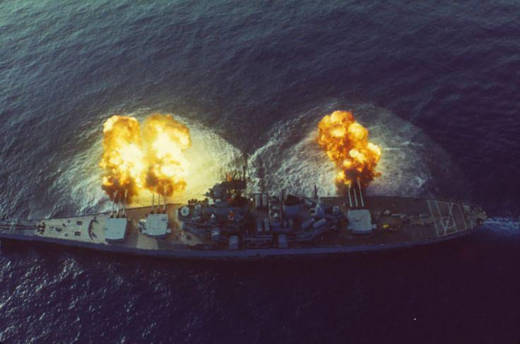 Aerial view of the USS New Jersey firing three of her 16 inch guns in 1982