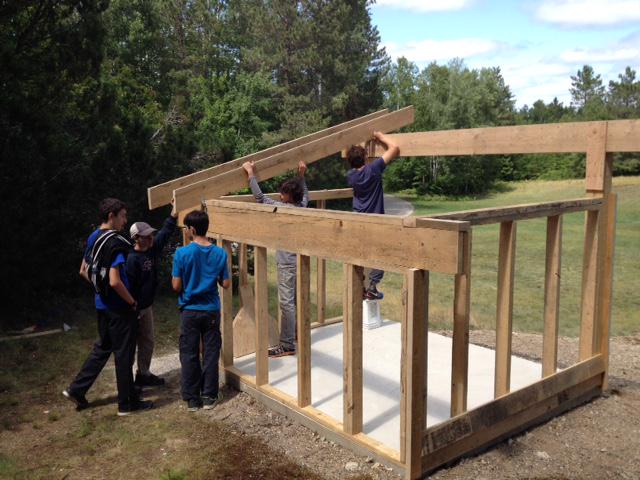 Adirondack project at Nominingue...campers involved in building shelter overlooking the archery range.