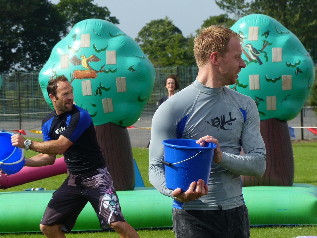 pupils &amp; staff (especially) enjoying It's A Knockout this morning. hope everyone has brought dry clothes and a towel