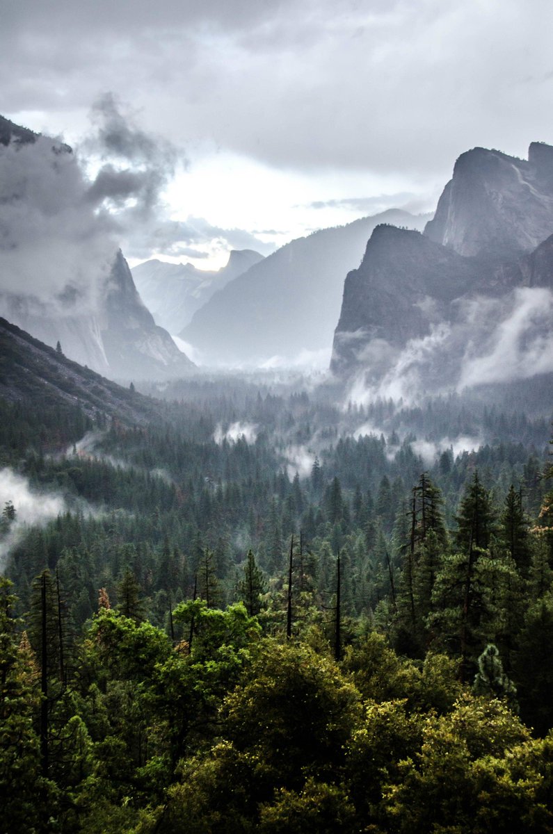 After a storm, the sun hiding behind the mighty Half Dome, Yosemite National Park