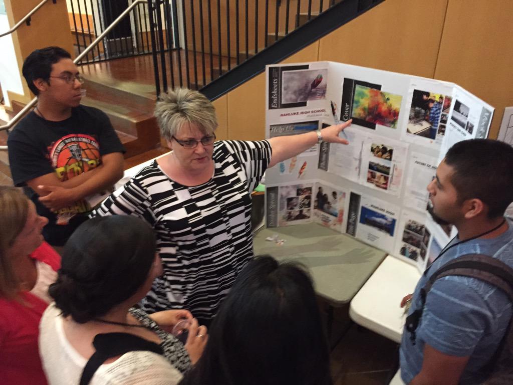 NWYBK's tweet photo. @loglesbee consulting @WahlukeHigh Yearbook Staff with their theme. Congrats on a great job! #WalsworthNW #NWYBK http://t.co/MMM4lCsD9G