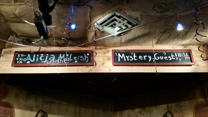 While Alicia McLeish is a local artist, our Mystery Guest tonight comes from afar. Early show starts in 30 minutes!