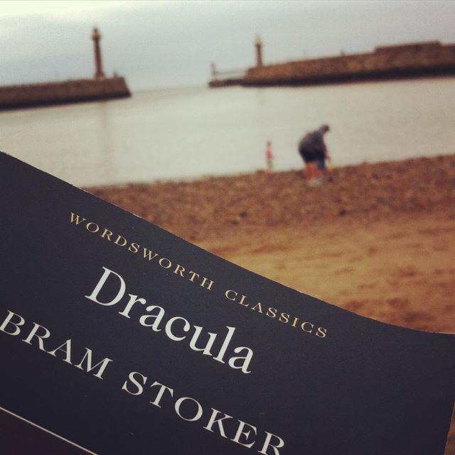 @whit_by by ejkearney_ Reading Dracula on Whitby beach 😺 #dracula #bramstoker #whitby #vampire #spooky