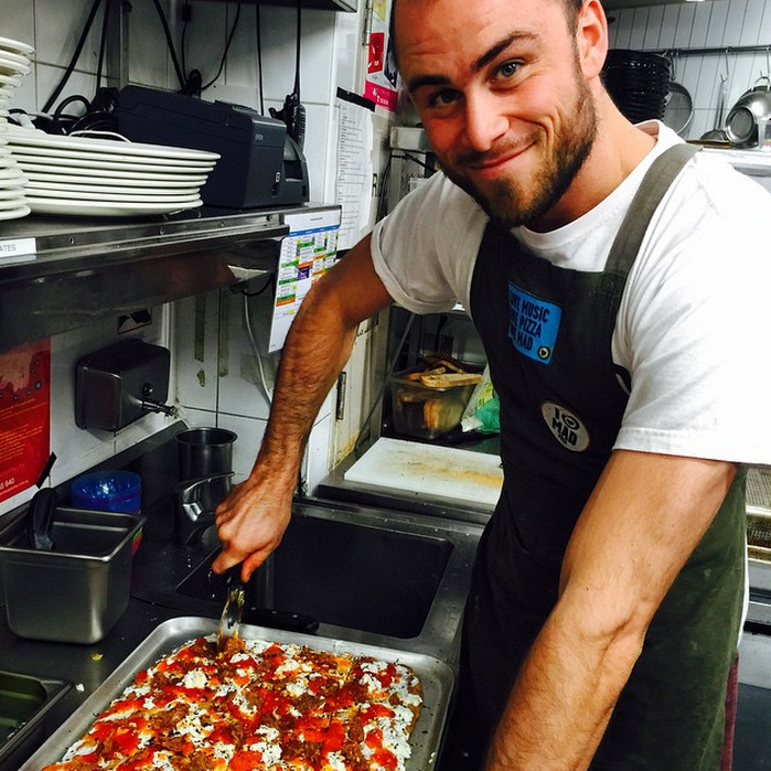 Our head cook making a  Persimmon, ricotta, Nduya (spicy sausage) topped with grated chocolate and hazelnuts!