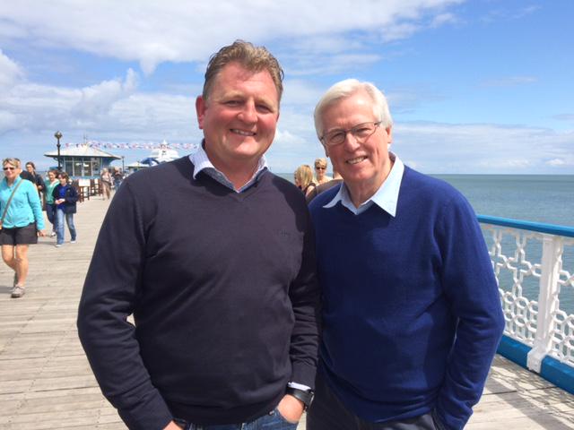 Tir Prince MD Adam Williams pictured with John Craven OBE whilst filming on the Pier for tonight's Country File