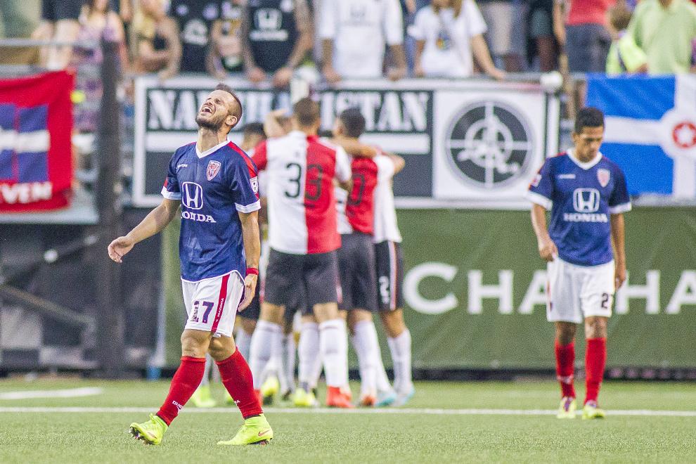 Stojkov reacts after the opponent scored a goal