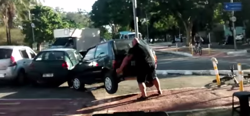 BleacherReport's tweet photo. VIDEO: Strong man calmly lifts entire car out of bicycle path, then continues on his way http://t.co/HFIzKyy6Zb http://t.co/MigXQfWcgA