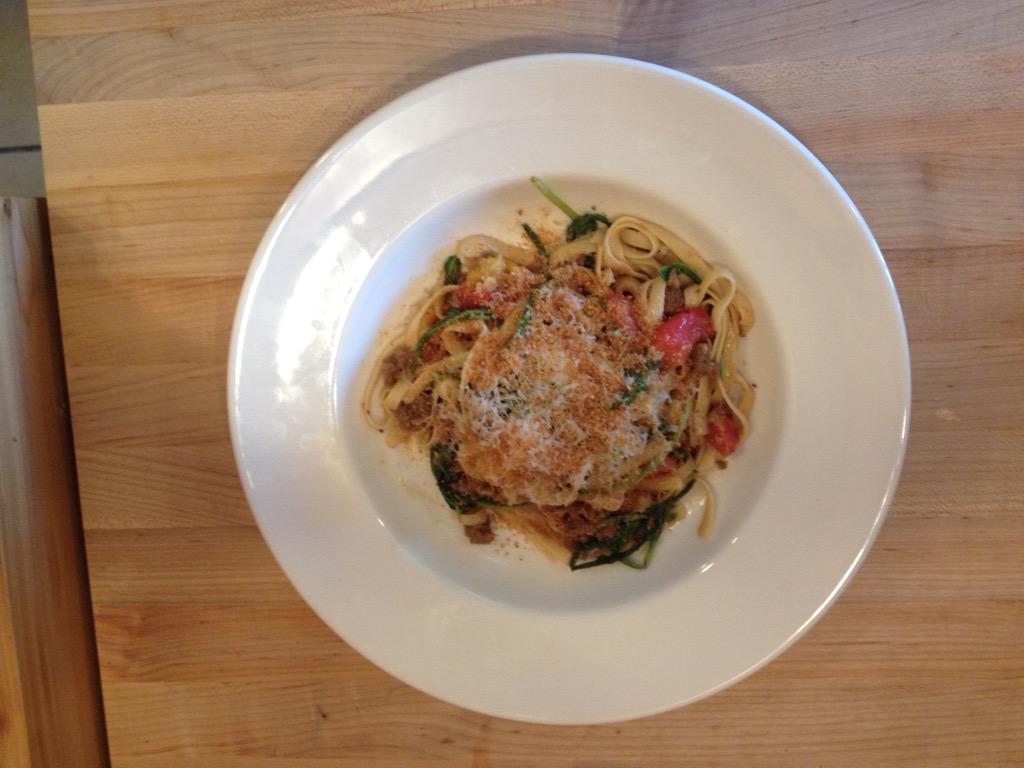 Fettuccine with heirloom tomatoes, spicy sausage and dandelion greens