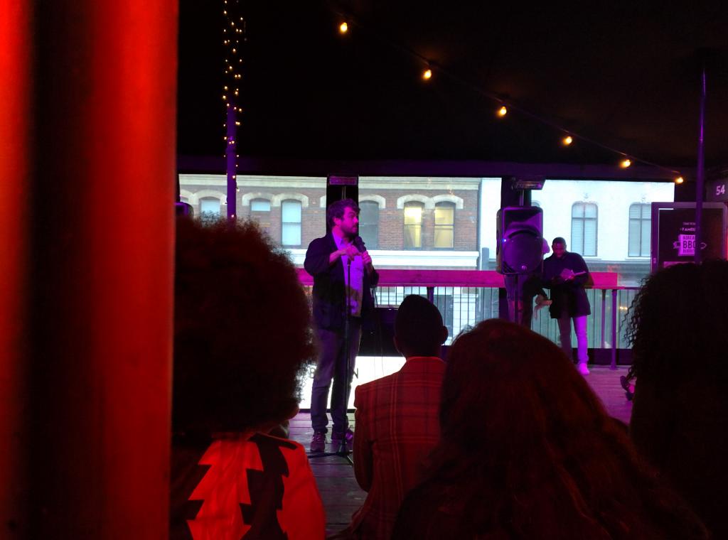 sparethepoets's tweet photo. @RossGSutherland doing his thing at #BoxediN last night! Amazing event, over 100 in the crowd! #SparethePoets #Poets http://t.co/G37KmEDEM3