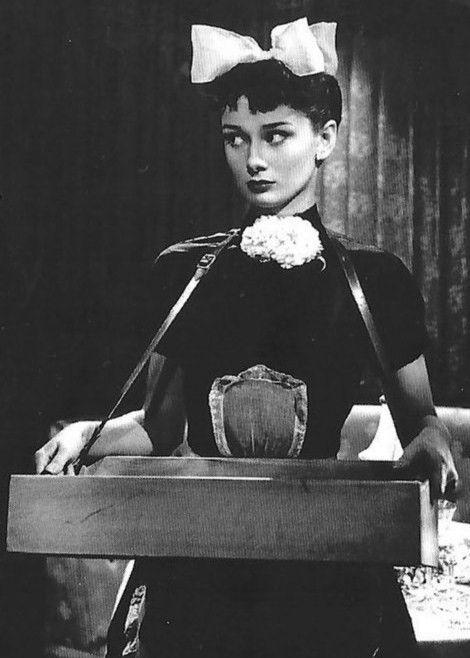 Audrey Hepburn as a cigarette girl in Laughter in Paradise (1951)