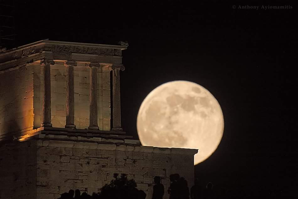 The supermoon rises above Athina Nike temple at Acropolis Athens Greece