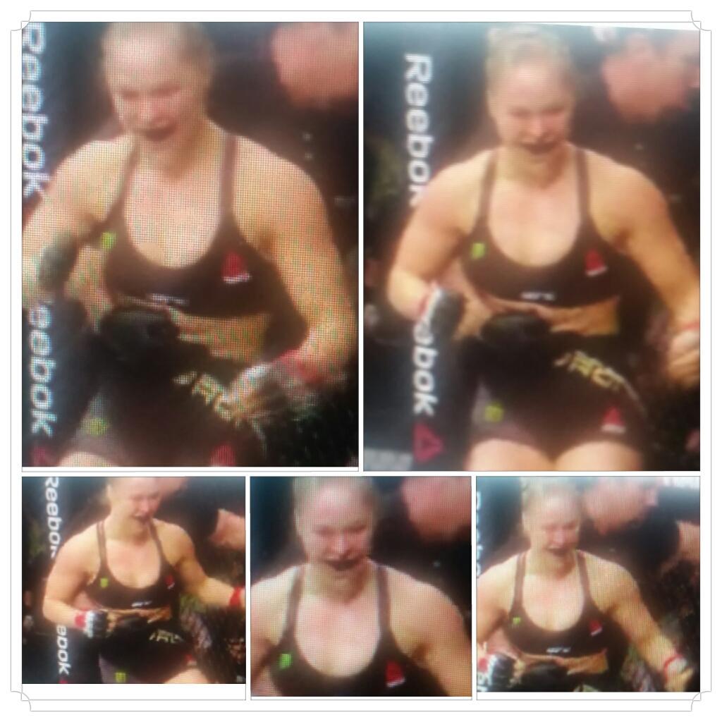 KaitlinDibble's tweet photo. Ronda Rhousey looking full of joy and and um, 'the dickens',  while getting yanked off Correia after 34 sec knockout. http://t.co/20iuRJICyA