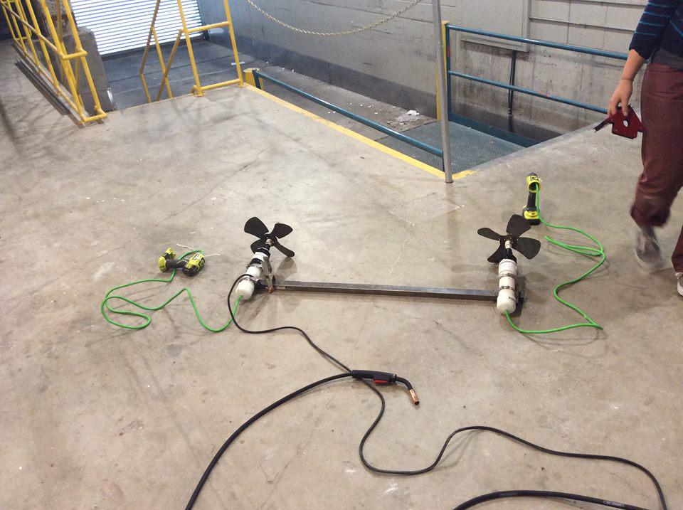 RobotGrrl's tweet photo. The #FabSub propulsion system. Drill motors inside pvc tubes connected to the propellers. Mounted on metal bar #Fab11 http://t.co/0fzepD0fAZ