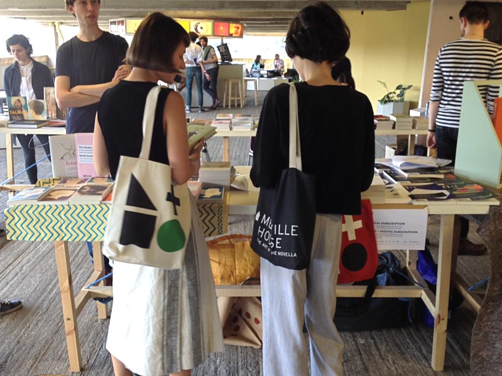 nplusonemag's tweet photo. Last day of @copelandbook! Make like this stylish tote-toters and come visit us in the Peckham car park. http://t.co/ja4aLeG8qs