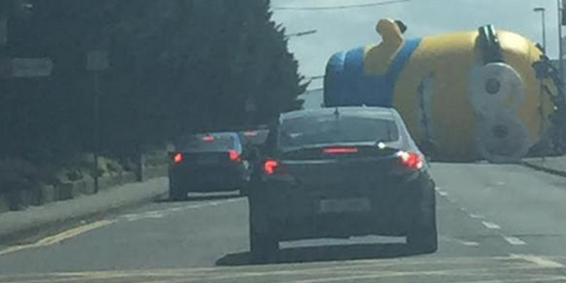 nzherald's tweet photo. Giant inflatable Minion causes havoc in Dublin after coming loose from its moorings http://t.co/cpvEwceTh4 http://t.co/Vuj1ZCPeQ8
