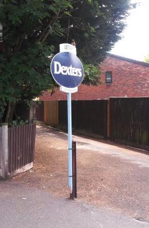 DavidCoxArt's tweet photo. A huge demand for affordable accommodation in Surbiton sees someone rent a short metal post in an alley. http://t.co/1uCxMEzi6O