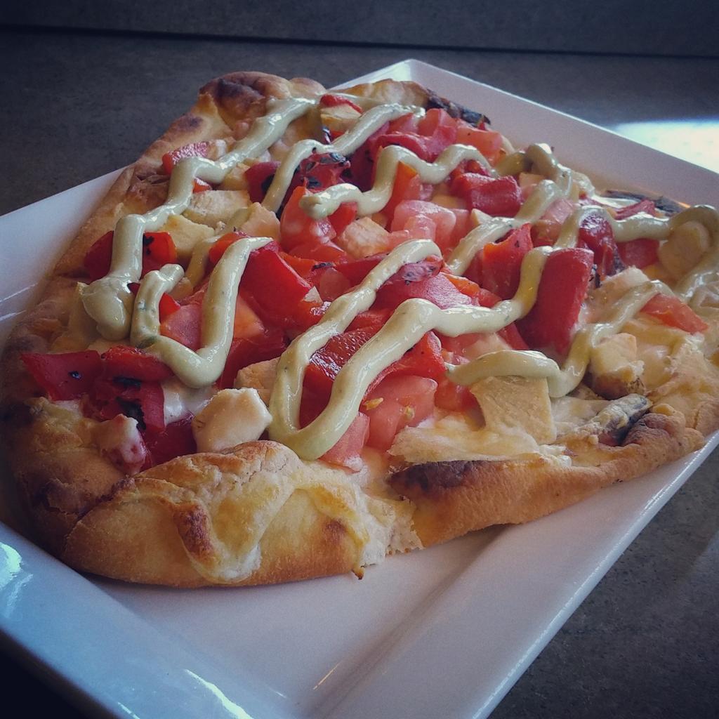 Chicken Flat Bread~Gorgonzola Cheese Spread, Roasted Chicken, Red Peppers, Tomato, and an Avocado Cilantro Sauce.