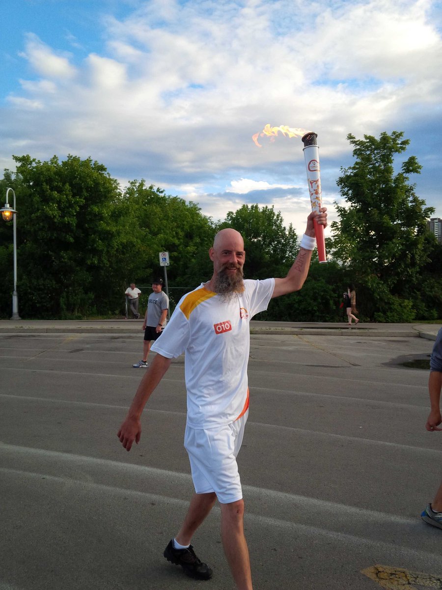 OLGtoday's tweet photo. OLG Torchbearer Tyson carries the flame high at Bayfront Pk in Hamilton #celebrateandshare #allforhere http://t.co/qm2f1PCc3A
