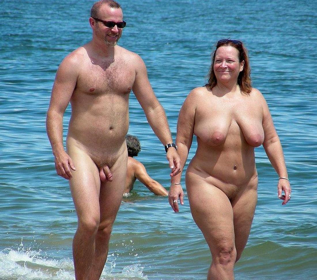 Middle age undress couple sun bath.