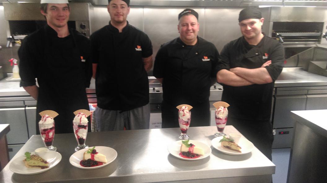 Happy chefs with their great puddings