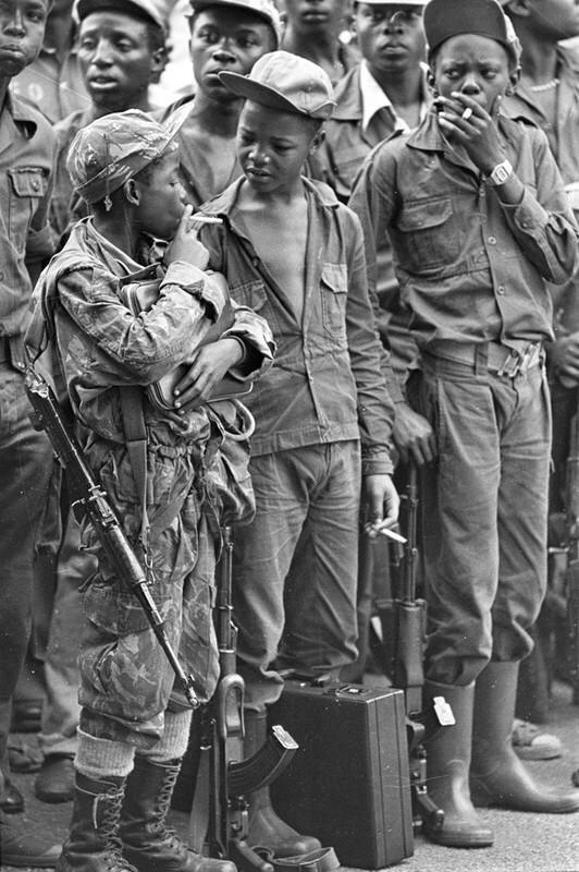 Child soldier smoking, Angola, 1976