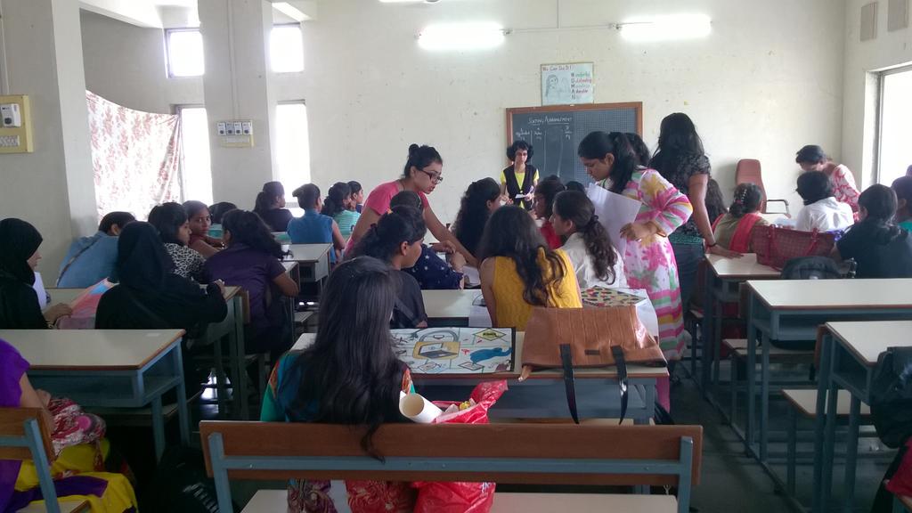The poster making contest's by SNDT ACM Students' Chapter distributing the posters to the respective contestants.