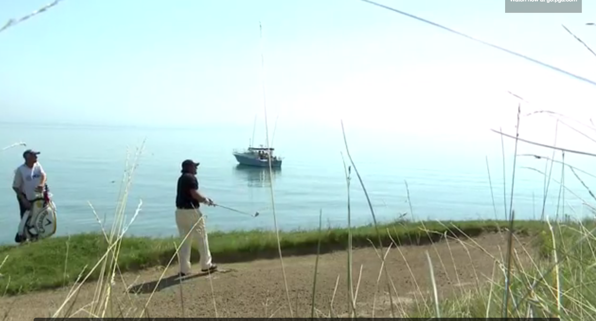 GolfDigest's tweet photo. Phil hits it to 3 feet from 179 yards out next to a bunker, proceeds to wave to boat. Watch: http://t.co/6ZhNFo0MwX http://t.co/crZKUXkQ1x