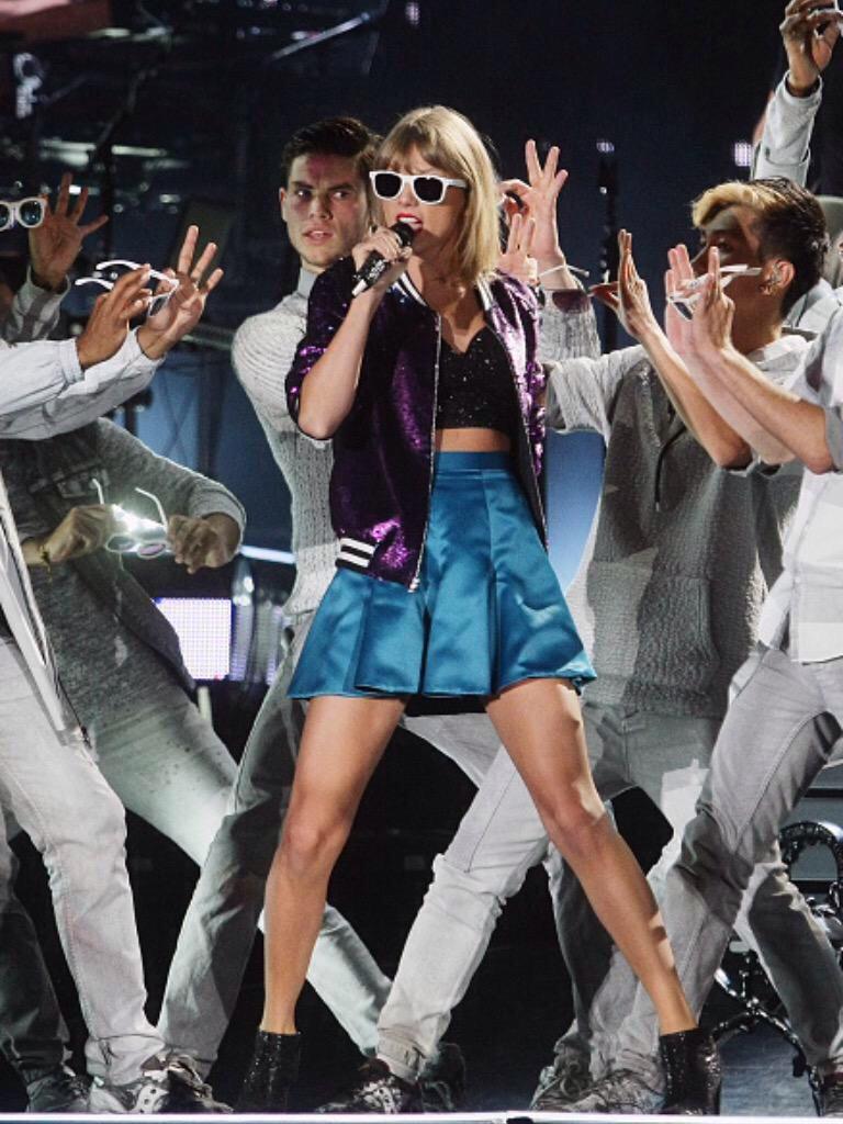 Taylor wearing a new purple jacket during Welcome To New York