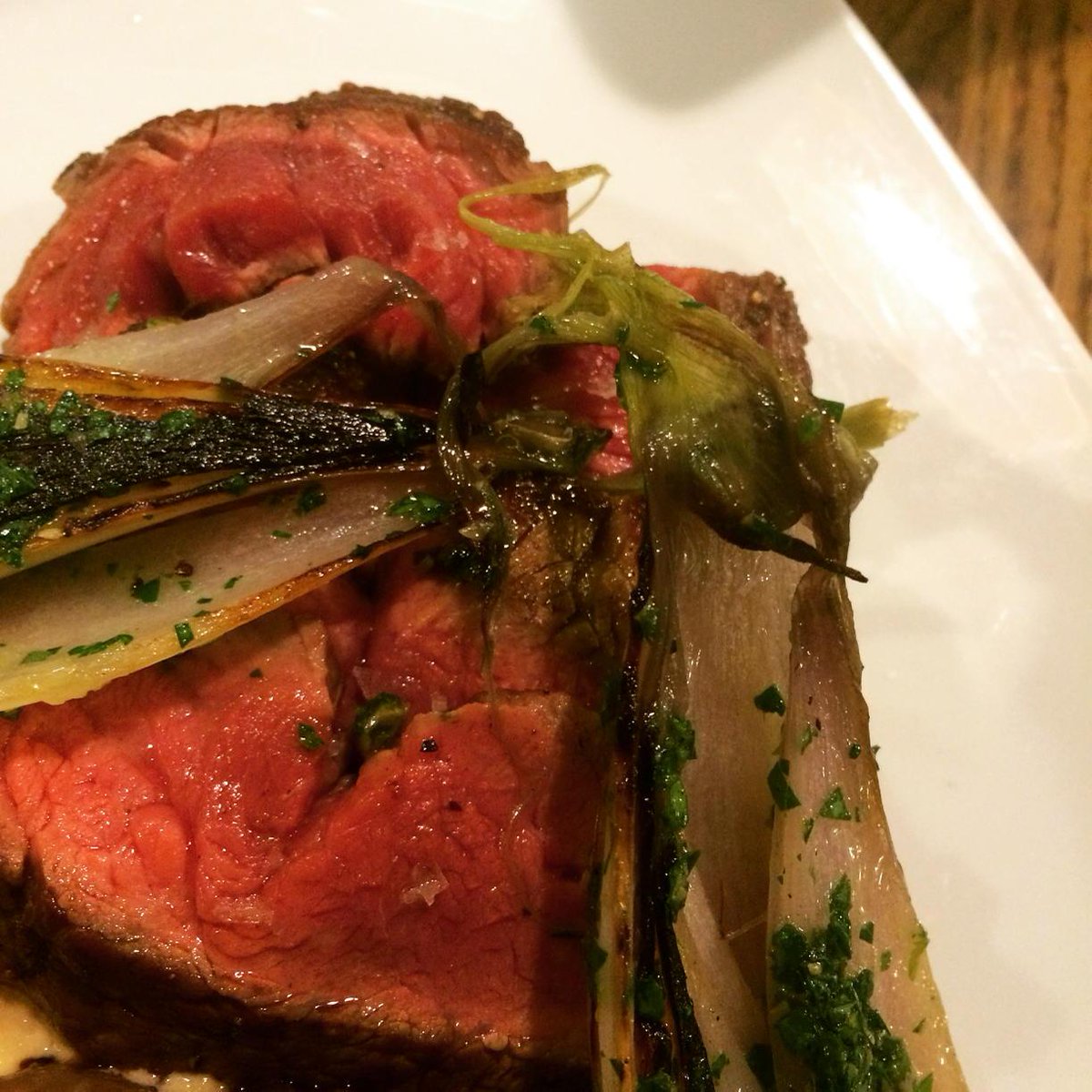 @paintedhllsbeef ribeye with grilled spring onions and salsa verde. #summersteak #worthit