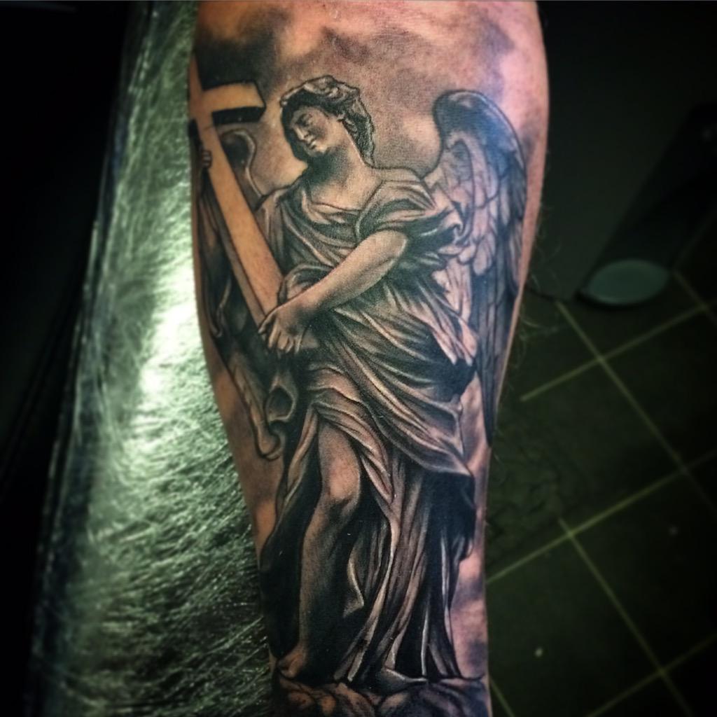 Angel with Cross Tattoo: Sacred Strength