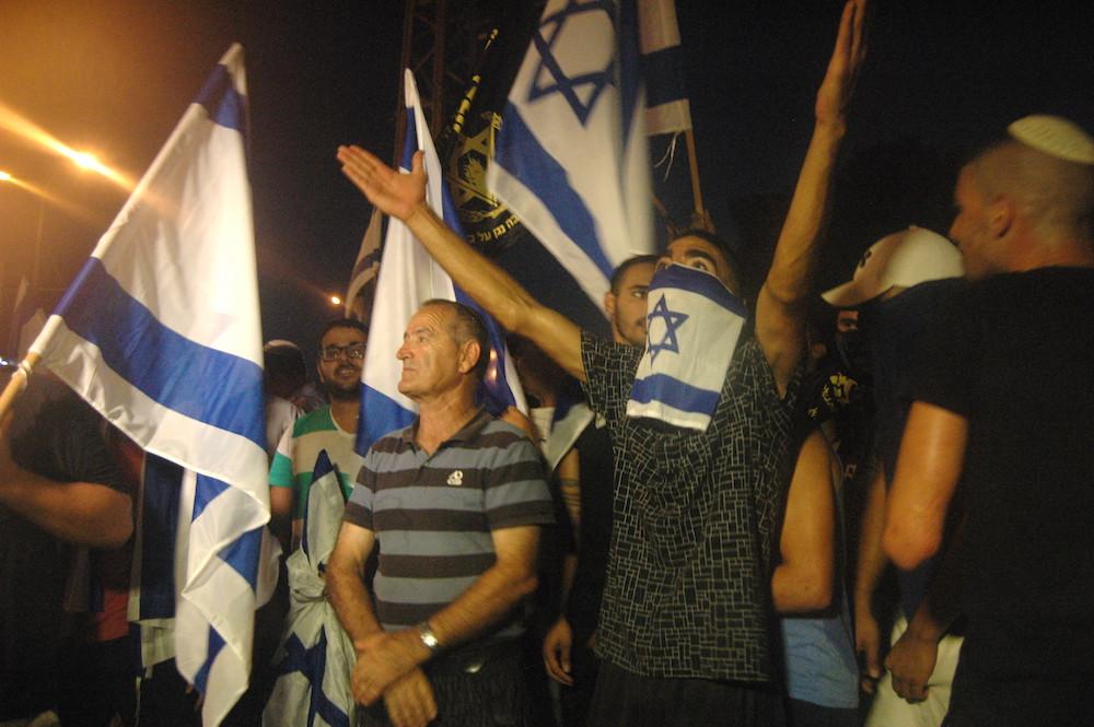 Mondoweiss's tweet photo. PHOTO: Right-wing Israelis in Ashkelon protest the presence of Palestinians inside the town http://t.co/MBiCFWc2f5 http://t.co/SL3aPxUt4k