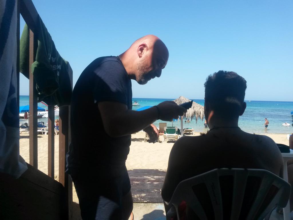Asked a lifeguard for wifi on Cyprus beach and ended up cutting his hair with his old tools! Wise Guys on tour 2015