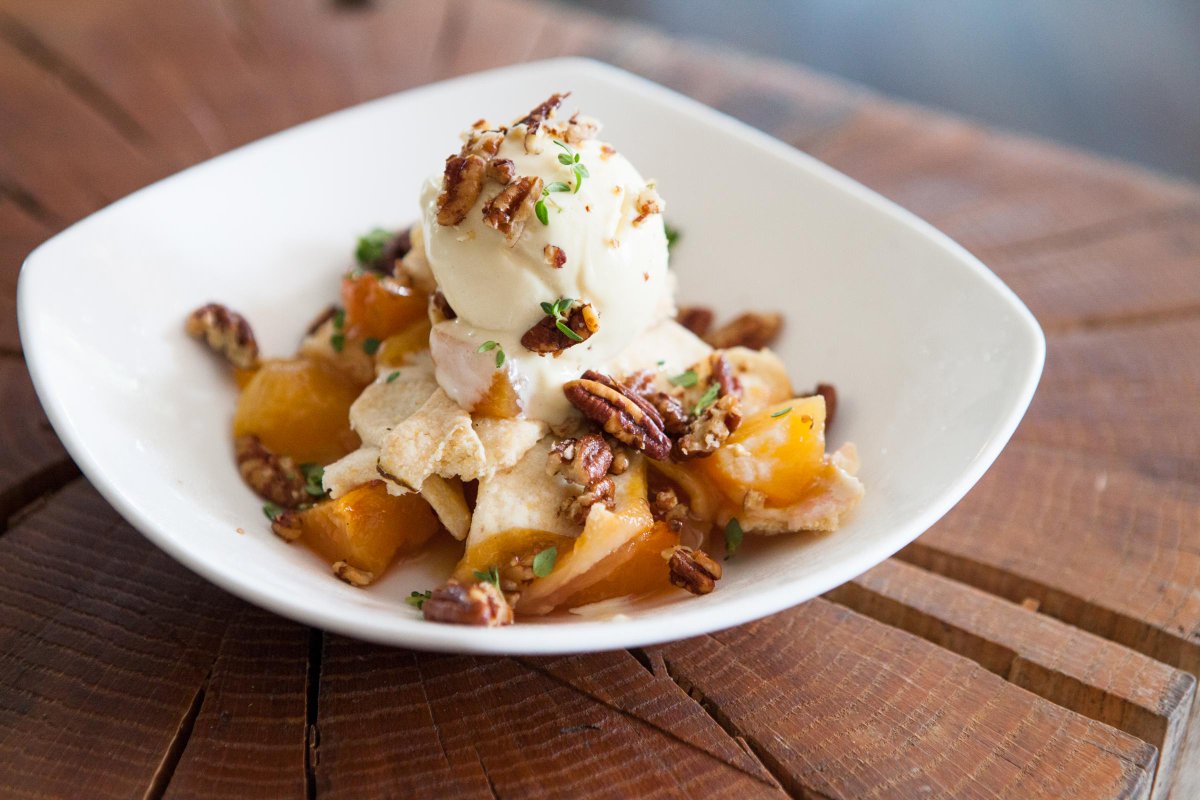 tazzakitchen's tweet image. Peaches. Pecans. Bourbon. Southern ingredients we love! The Peach Crumble has 'em all. Save some room y’all.