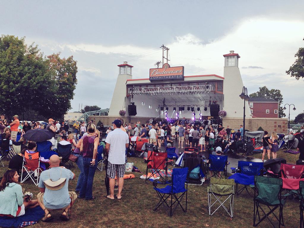 SyrNewTimes's tweet photo. Concerts are better in the rain. Great turnout so far for @JJGREYandMOFRO @bhtm and @glove at #papermillisland http://t.co/Y5Cwpejsmz