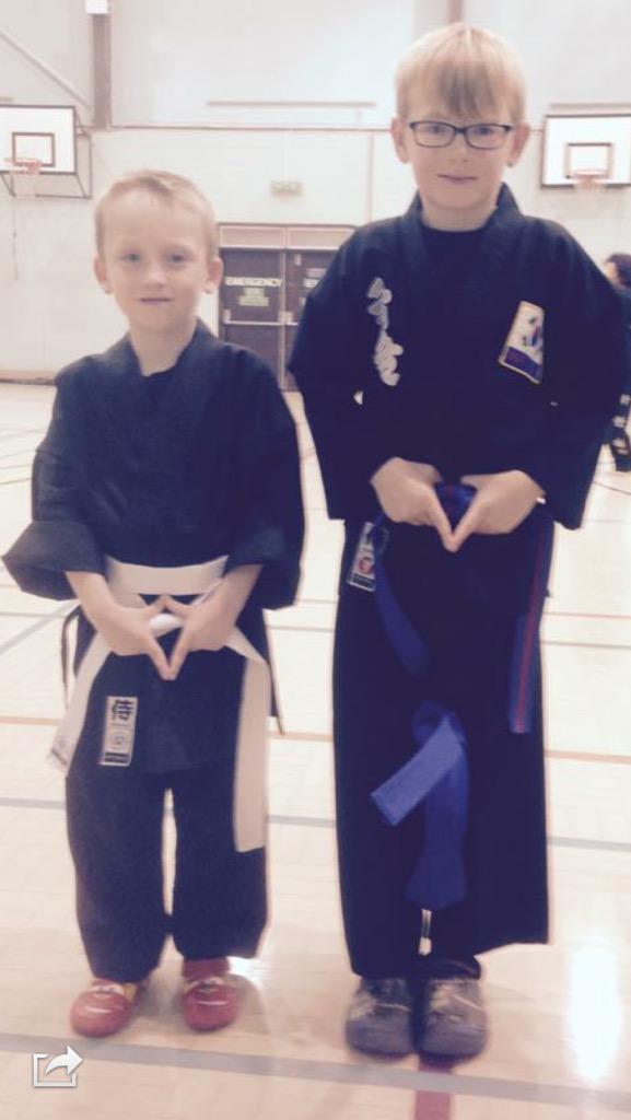 Alfie receiving his new belt after testing and Dexter getting his first suit and white belt well done boys