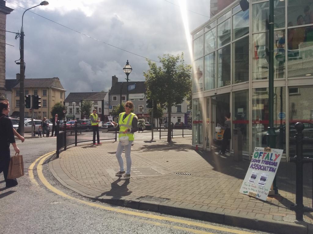 Offaly down syndrome assoc members out shaking the first few  tour de leinster  buckets while dodging showers
