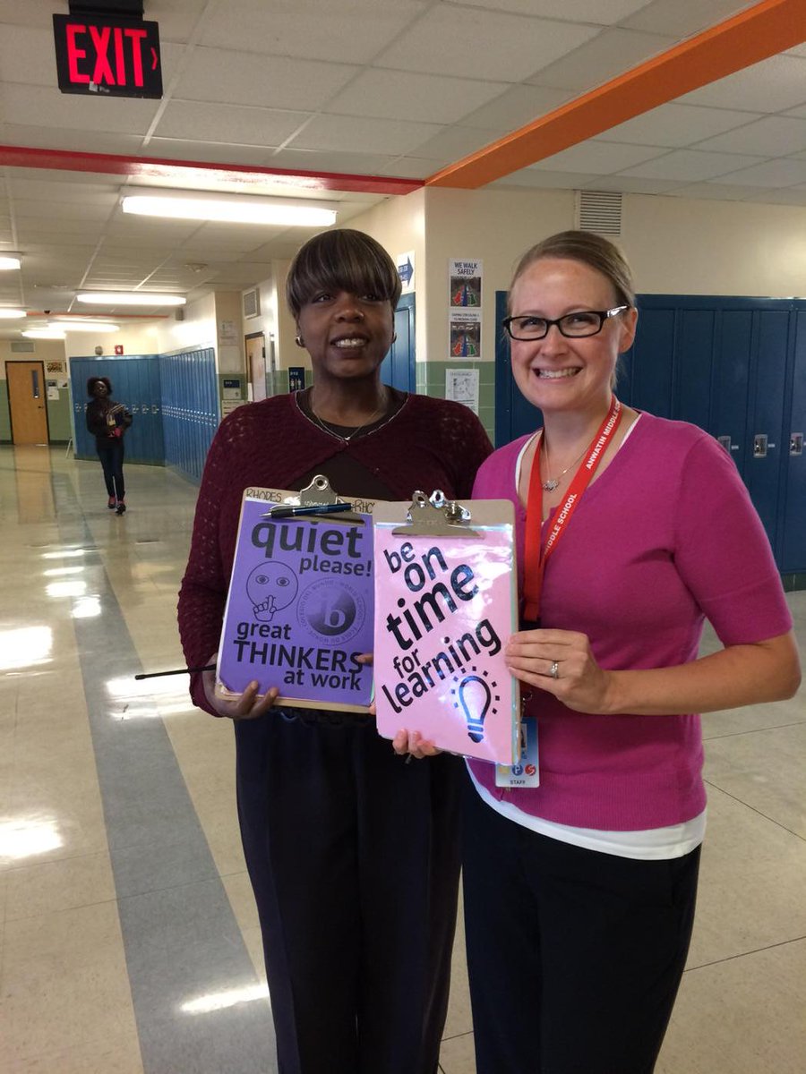 Anwatin staff w Envoy non- verbal visual signs in the hallway@MPSMultilingual