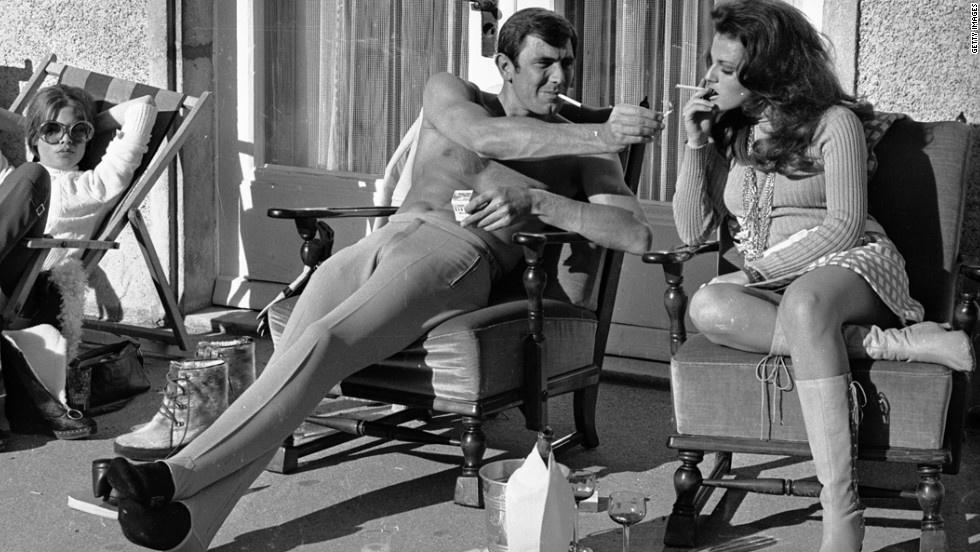 George Lazenby offers Helena Ronee a light on the set of ON HER MAJESTY S SECRET SERVICE. Happy birthday Mr. Lazenby 