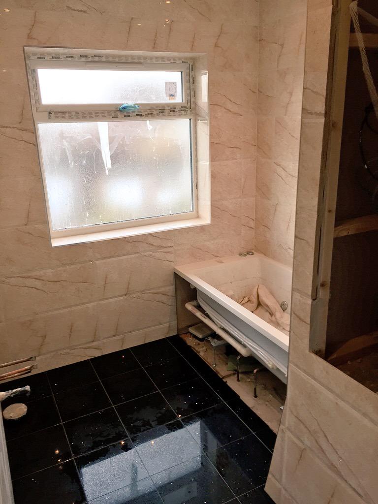 Bathroom tiling completed using black Quartz tiles on the floor. All materials supplied by <a href="/toppstiles/">Topps Tiles</a>