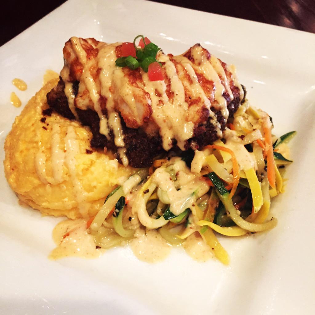Tonight's dinner feature: Parmesan Crab Crusted Grouper served over cheese grits with sautéed vegetables.