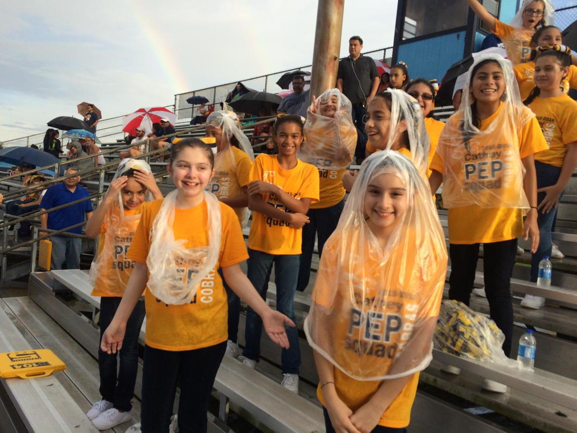 Cathey Pep Squad cheering on the #Cobras in the rain