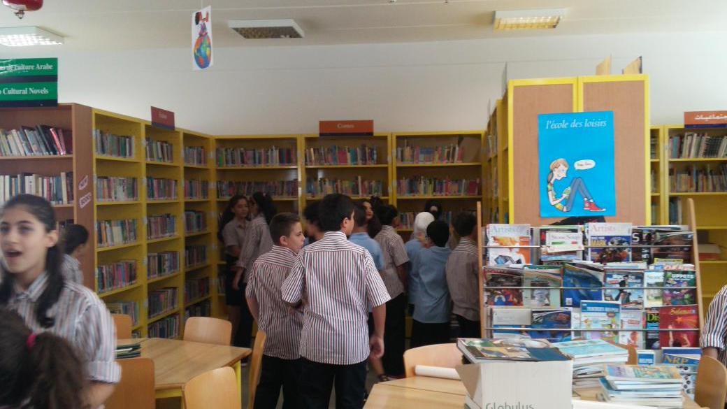<a href="/Hhhsinfo/">Houssam Hariri HS</a> grade 6 learners exploring middle school library. Welcome visitors! #newcomers #school #library