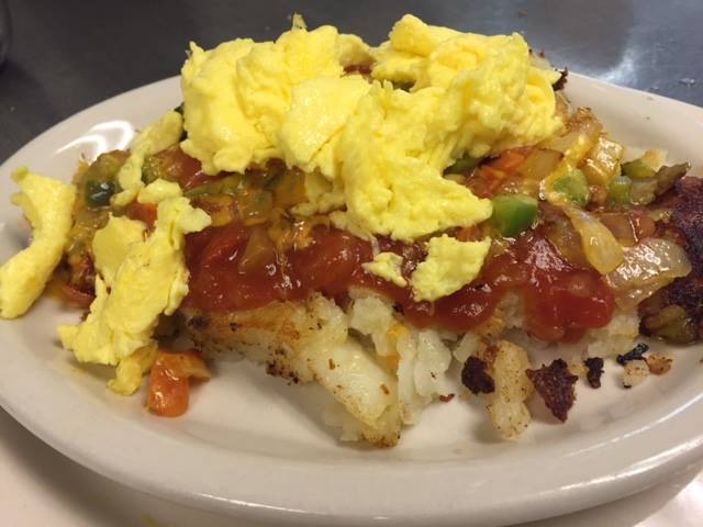 Salsa Skillet: Home fries topped with green peppers, onions, tomatoes, melted cheddar cheese, salsa + farm fresh eggs